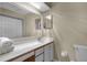 Bright bathroom featuring a vanity with countertop and a framed mirror at 179 Crown Point Cir, Longwood, FL 32779