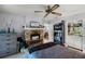 Bedroom featuring a stone fireplace, ceiling fan, and built-in shelving at 179 Crown Point Cir, Longwood, FL 32779