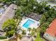 Overhead shot of sparkling community pool with lounge area and mature landscaping at 179 Crown Point Cir, Longwood, FL 32779