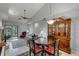 Open concept dining area with vaulted ceiling, modern light fixture, and display cabinet at 179 Crown Point Cir, Longwood, FL 32779