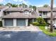 Inviting townhouse featuring attached garage, mature landscaping, and guest parking at 179 Crown Point Cir, Longwood, FL 32779