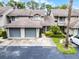 Inviting townhouse featuring attached garage, mature landscaping, and guest parking at 179 Crown Point Cir, Longwood, FL 32779