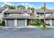 Inviting townhouse featuring attached garage, mature landscaping, and guest parking at 179 Crown Point Cir, Longwood, FL 32779