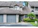 Close-up of townhouse with attached garage and well-maintained landscaping at 179 Crown Point Cir, Longwood, FL 32779