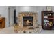 Stone fireplace with glass doors and hearth is a great focal point at 179 Crown Point Cir, Longwood, FL 32779
