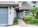 Charming townhouse entrance with manicured landscaping and dark gray door at 179 Crown Point Cir, Longwood, FL 32779