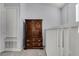 Hallway area showcasing a wooden storage unit with drawers and cabinet at 179 Crown Point Cir, Longwood, FL 32779