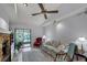 Bright living room featuring stone fireplace, ceiling fan, and sliding doors to patio at 179 Crown Point Cir, Longwood, FL 32779
