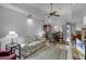 Well-lit living room featuring vaulted ceiling, fan, and neutral color palette at 179 Crown Point Cir, Longwood, FL 32779