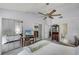 Spacious main bedroom featuring mirrored closets, a ceiling fan, and ensuite bathroom access at 179 Crown Point Cir, Longwood, FL 32779