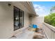 Outdoor patio with a sliding door and a partial view of the building's exterior at 179 Crown Point Cir, Longwood, FL 32779