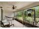 Relaxing screened porch with a hammock, ceiling fan, and views of the natural surroundings at 179 Crown Point Cir, Longwood, FL 32779