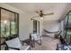 Relaxing screened porch with a hammock, ceiling fan, and seating area at 179 Crown Point Cir, Longwood, FL 32779