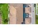 Top down aerial view of the home featuring the tile roof, screened-in pool and lush landscaping at 1943 Majorca Dr, Kissimmee, FL 34747