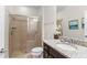 Well-lit bathroom features granite countertop, tile shower, and ceramic tile flooring at 1943 Majorca Dr, Kissimmee, FL 34747