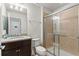 Bathroom with granite counters, shower, and neutral tile flooring at 1943 Majorca Dr, Kissimmee, FL 34747