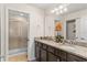 Bright bathroom featuring dual sinks with granite counters and a glass-enclosed shower at 1943 Majorca Dr, Kissimmee, FL 34747