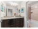 Updated bathroom featuring granite counters, dual sinks, and a shower-tub combo at 1943 Majorca Dr, Kissimmee, FL 34747