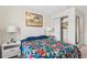 Cozy bedroom with a large window, floral bedding, closet, and neutral walls at 1943 Majorca Dr, Kissimmee, FL 34747