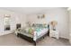 Light and airy bedroom with twin nightstands and a view into the bath at 1943 Majorca Dr, Kissimmee, FL 34747