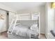 Cozy bedroom featuring a bunk bed with a sturdy ladder, neutral walls, and a closet with ample storage space at 1943 Majorca Dr, Kissimmee, FL 34747