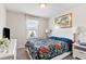 Bedroom with a bright window, floral bedding, and neutral walls at 1943 Majorca Dr, Kissimmee, FL 34747