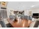 Dining area with a wooden table set and seamless access to an open concept kitchen and living space at 1943 Majorca Dr, Kissimmee, FL 34747