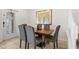 Dining room with tile floors features a rustic table and a door offering seamless access to outdoor at 1943 Majorca Dr, Kissimmee, FL 34747