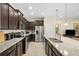 Bright kitchen features stainless appliances, granite counters, dark cabinetry, and tile floors at 1943 Majorca Dr, Kissimmee, FL 34747