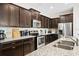 Kitchen with granite countertops, stainless steel appliances, and dark wood cabinetry at 1943 Majorca Dr, Kissimmee, FL 34747