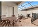 Outdoor patio with a dining set, lounge chairs, brick flooring, grilling area and screened-in ceiling at 1943 Majorca Dr, Kissimmee, FL 34747