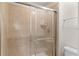 Shower featuring neutral tiling and glass doors at 1943 Majorca Dr, Kissimmee, FL 34747