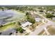 An aerial perspective reveals a pool, situated near a tranquil lake and surrounded by lush greenery at 1962 English Dr, Deltona, FL 32738