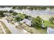 Aerial view of lakeside house featuring mature trees, a glimpse of a lake view, and close proximity to the water's edge at 1962 English Dr, Deltona, FL 32738