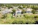 Expansive aerial view of a quaint neighborhood featuring well-maintained homes, lush greenery and a private backyard pool at 1962 English Dr, Deltona, FL 32738