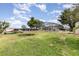 A very large backyard featuring a screened-in pool enclosure, storage sheds, and grassy area at 1962 English Dr, Deltona, FL 32738