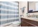 Bathroom featuring a vanity and sink, toilet, and shower with a blue and white striped curtain at 1962 English Dr, Deltona, FL 32738