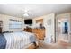 Comfortable bedroom featuring neutral walls, carpeted floors, a ceiling fan, and a tidy wood dresser with mirror at 1962 English Dr, Deltona, FL 32738
