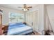 Comfortable bedroom featuring a ceiling fan, closet, and a sunlit window providing a bright and airy atmosphere at 1962 English Dr, Deltona, FL 32738