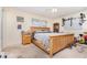 A bedroom featuring a wood-framed bed, side table, and closet, illuminated by natural light from the windows at 1962 English Dr, Deltona, FL 32738