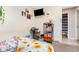 A bedroom featuring a bed, shelves, closet, illuminated by natural light from the windows at 1962 English Dr, Deltona, FL 32738