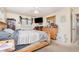 A bedroom featuring a wood-framed bed, wood dresser, and closet, illuminated by natural light from the windows at 1962 English Dr, Deltona, FL 32738