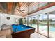 Bright game room featuring a pool table with sliding glass doors, leading to an inviting screened in pool at 1962 English Dr, Deltona, FL 32738