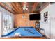 Recreational room featuring a blue pool table, wood paneled walls, flat screen TV, and ceiling fan at 1962 English Dr, Deltona, FL 32738
