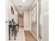 Inviting hallway with neutral tones, tile flooring, and a decorative table with a mirror at 1962 English Dr, Deltona, FL 32738
