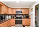 Kitchen features granite countertops, oak cabinetry, and stainless steel appliances at 1962 English Dr, Deltona, FL 32738