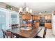 Eat-in kitchen featuring wooden cabinets, stainless steel appliances, and a striking light fixture over the dining table at 1962 English Dr, Deltona, FL 32738