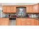Kitchen featuring stainless dishwasher, granite countertops and oak cabinets at 1962 English Dr, Deltona, FL 32738