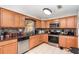 Kitchen features granite countertops, oak cabinetry, and tile backsplash at 1962 English Dr, Deltona, FL 32738