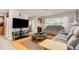 Comfortable living room with hardwood floors, plush sofas, and natural light from the large window at 1962 English Dr, Deltona, FL 32738